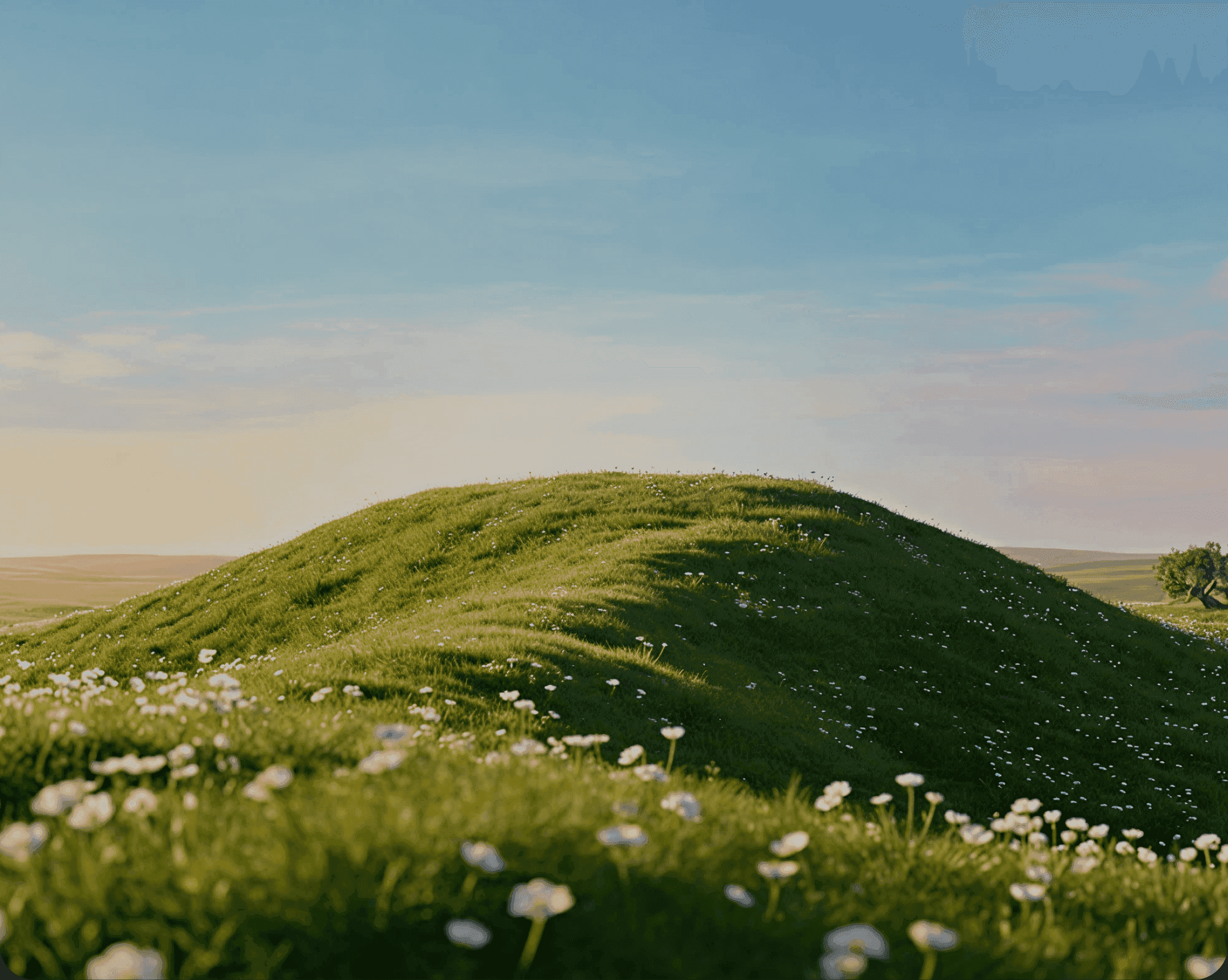 Grassy hill under an evening sky